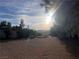 Large lot with trees, desert landscape, and beautiful mountain views on a sunny day at 3491 S Bridle Way, Crystal, NV 89020