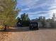 Spacious lot with mature landscaping and plenty of parking on a sunny day at 3491 S Bridle Way, Crystal, NV 89020