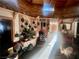 Living room with wood walls, wood stove, vintage decor, and natural light at 3491 S Bridle Way, Crystal, NV 89020