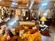 Open living room with wood paneled ceiling, cozy furniture, and golden retrievers at 3491 S Bridle Way, Crystal, NV 89020