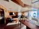 Cozy living room features wood beam ceiling, light wood paneled walls, and comfortable seating at 3491 S Bridle Way, Crystal, NV 89020