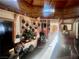 Living room with wood walls, wood stove, vintage decor, and natural light at 3491 S Bridle Way, Crystal, NV 89020