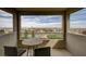 Outdoor balcony with table and chairs showing views of nearby homes and beautiful blue sky at 350 Gandara St, Las Vegas, NV 89138