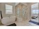 Luxurious bathroom featuring a soaking tub, glass shower, and elegant tile flooring at 350 Gandara St, Las Vegas, NV 89138