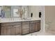 Elegant bathroom featuring dual vanities with marble countertops, updated cabinets, and modern fixtures at 350 Gandara St, Las Vegas, NV 89138