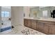 Stylish bathroom featuring dual vanities with marble countertops, updated cabinets, and modern fixtures at 350 Gandara St, Las Vegas, NV 89138