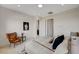 Well-lit bedroom featuring a plush king bed, cozy accent chair, and minimalist design at 350 Gandara St, Las Vegas, NV 89138