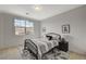 Comfortable bedroom with a black metal bedframe, black bedside table, and a large window with views of the community at 350 Gandara St, Las Vegas, NV 89138