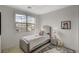 This charming bedroom features a soft bed, neutral decor, and a large window with neighborhood views at 350 Gandara St, Las Vegas, NV 89138