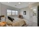 Bright bedroom with large window, comfortable king bed, accent chair, and neutral decor at 350 Gandara St, Las Vegas, NV 89138