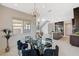 Open concept dining room featuring modern chandelier, glass table, and kitchen access at 350 Gandara St, Las Vegas, NV 89138