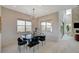 This dining room features modern chandelier, glass table, and large windows with neighborhood views at 350 Gandara St, Las Vegas, NV 89138