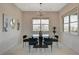 Bright dining room featuring modern chandelier, glass table, and large windows with neighborhood views at 350 Gandara St, Las Vegas, NV 89138