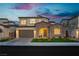 Beautiful two-story home featuring a stone facade, manicured lawn, and a spacious two-car garage at 350 Gandara St, Las Vegas, NV 89138