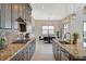 Elegant kitchen featuring granite countertops, dark wood cabinetry, and adjacent dining area at 350 Gandara St, Las Vegas, NV 89138