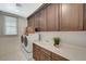 Laundry room with a sink, plenty of cabinet space, and a modern washer and dryer at 350 Gandara St, Las Vegas, NV 89138