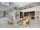 Expansive living room boasts a staircase, kitchen view, and elegant railings overlooking the open space at 350 Gandara St, Las Vegas, NV 89138