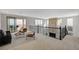 Open living room with neutral walls, stylish furniture and a beautiful fireplace with stone surround at 350 Gandara St, Las Vegas, NV 89138