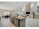 Open-concept living space with a stone fireplace, large windows, and seamless transition to the dining and kitchen areas at 350 Gandara St, Las Vegas, NV 89138