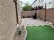 Paver patio with synthetic grass featuring a barbecue grill, enclosed by a privacy wall at 355 Gracious Way, Henderson, NV 89011