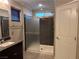 Bathroom showcasing glass-enclosed shower, a single vanity, and tile flooring at 355 Gracious Way, Henderson, NV 89011