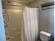 Clean bathroom featuring tiled shower with caddy and seat, toilet, and a black wire shelf at 355 Gracious Way, Henderson, NV 89011