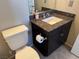 Bathroom featuring dark cabinets, a granite countertop, and a toilet with classic fixtures at 355 Gracious Way, Henderson, NV 89011
