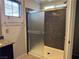 Modern bathroom highlighting glass enclosed shower with gray stone-look tile and window at 355 Gracious Way, Henderson, NV 89011
