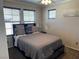 Cozy bedroom featuring neutral tones, natural light, ceiling fan, and a comfortable queen-size bed at 355 Gracious Way, Henderson, NV 89011