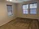 Empty carpeted bedroom showcasing multiple windows for natural light at 355 Gracious Way, Henderson, NV 89011