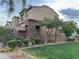 Charming multi-story townhouse featuring stone accents and desert landscaping, with an attached garage at 355 Gracious Way, Henderson, NV 89011