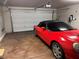 Garage featuring an automatic door, EV charging outlet, and a parked red convertible at 355 Gracious Way, Henderson, NV 89011