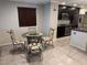 A kitchen featuring a dining area, granite countertops, stainless steel appliances, and ample cabinets at 355 Gracious Way, Henderson, NV 89011