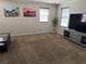 Bright, spacious living room with a large television, a media console, and artwork at 355 Gracious Way, Henderson, NV 89011