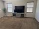 Bright living room with a large television, media console, and three windows at 355 Gracious Way, Henderson, NV 89011