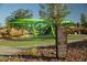 A modern playground with green climbing structure and signage in a well-maintained park area at 355 Gracious Way, Henderson, NV 89011