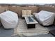 Comfortable rooftop deck with outdoor seating and a stylish fire pit feature on a striped rug at 355 Gracious Way, Henderson, NV 89011
