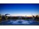 A fun splash pad area with water features and a scenic city view on the horizon at dusk at 355 Gracious Way, Henderson, NV 89011