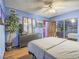 Bedroom with light blue walls, dark wood floors, and an accent wall with a full view mirror at 438 Las Casitas Way, Las Vegas, NV 89121