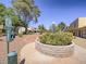 Community green space with a pet waste station near beige townhomes under a clear sky on a sunny day at 438 Las Casitas Way, Las Vegas, NV 89121