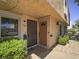 Townhouse exterior featuring a secured entry and decorative bushes at 438 Las Casitas Way, Las Vegas, NV 89121