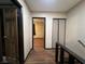 Hallway with hardwood floors, neutral walls, and door to bedroom and closet at 438 Las Casitas Way, Las Vegas, NV 89121