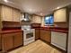 Cozy kitchen featuring wooden cabinets, white appliances, and warm countertops at 438 Las Casitas Way, Las Vegas, NV 89121