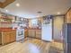 Bright kitchen features laminate floors, wood cabinets, and white appliances at 438 Las Casitas Way, Las Vegas, NV 89121