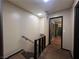Upstairs hallway with modern staircase and view of a bedroom through an open door at 438 Las Casitas Way, Las Vegas, NV 89121
