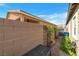 Cozy backyard featuring a brick perimeter wall, patio pavers, and lush shrubbery at 4505 Meline Ave, North Las Vegas, NV 89084