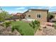 Well-maintained backyard featuring a hot tub, patio, artificial turf, and xeriscaping at 4505 Meline Ave, North Las Vegas, NV 89084