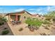 Backyard with patio, dining set, covered porch, and desert landscaping at 4505 Meline Ave, North Las Vegas, NV 89084