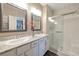 Clean bathroom featuring dual sinks, granite countertops, and a walk-in shower at 4505 Meline Ave, North Las Vegas, NV 89084