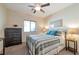 Cozy bedroom with a metal bed frame, ceiling fan, and neutral-toned walls and decor at 4505 Meline Ave, North Las Vegas, NV 89084